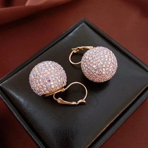 Luxury gold earrings with colorful rhinestones on a sphere-shaped design displayed on a box