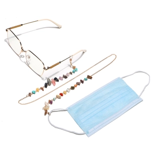 Detail of colorful natural stones on gold chain for glasses or face masks