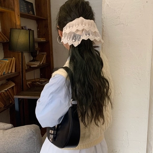 Elegant beige lace scrunchie with floral embroidery for women in a cozy home setting