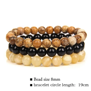 Detailed view of 8mm natural stone bead bracelets in brown, black, and beige textures