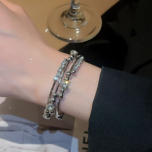 Macro shot of silver multi-layer geometric cuff bracelet with shimmering crystals