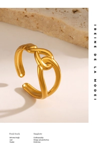 Detail of gold-plated crossover ring showing smooth lines and matte texture