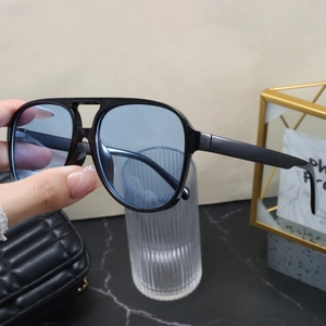 Close-up of pilot style sunglasses with double bridge frame and light blue ocean lenses