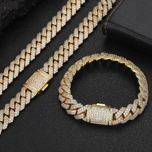 Detailed view of 12mm gold-tone cuban chain necklace and bracelet with zircon inlay
