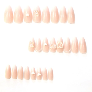 Sweet pink gradient almond press-on nails with 3D bows, pearls, and heart charms