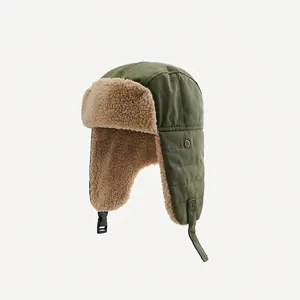 Detail of army green trapper hat featuring warm faux lamb wool lining and chin strap buckle