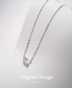 Macro shot of a marquise-cut zircon pendant on a silver-tone chain necklace