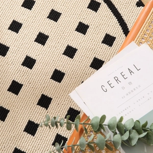 Round thickened geometric woven rug with black and white checkerboard pattern for home decor