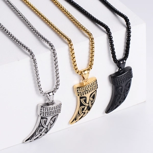 Detailed view of Celtic knot horn pendants in gold, silver and black on display