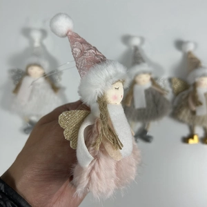 Close-up of pink plush angel ornament with sequin wings and a soft faux fur skirt