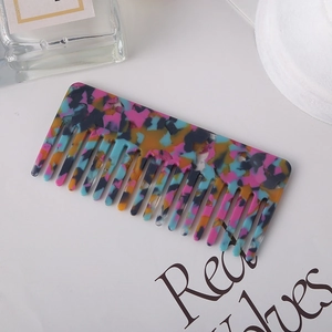 Detail view of the floral pattern texture on a high-quality acetate hair comb