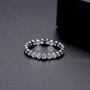 Elegant silver ring featuring full circular bezel-set round cubic zirconia stones