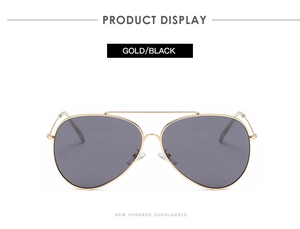 Detail of classic aviator sunglasses featuring a slim gold metal frame and black lenses