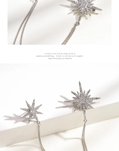 Close-up of silver star earrings with micro-set zircons and elegant long tassel chains