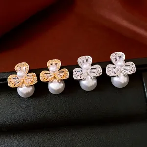 French style flower pearl earrings set with zircon stones on dark silk backdrop
