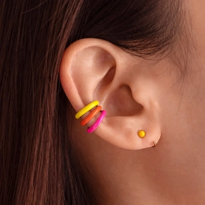 S925 silver ear cuff set with vibrant yellow, orange, and pink enamel on a female ear