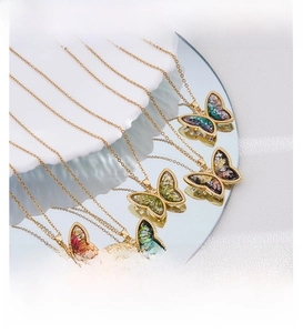 Detail view of 18K gold plated butterfly necklaces with colorful resin stone inlay