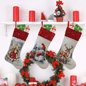 Detailed close-up of three Christmas stockings with Santa, snowman and reindeer designs