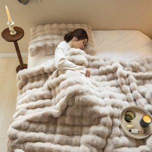 Plush beige faux rabbit fur throw blanket for sofa and bed with a soft thick texture