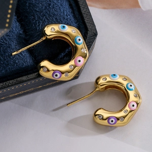 Gold C-shaped earrings with colorful evil eye patterns and sparkling zircon accents