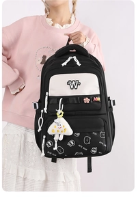 Detail of cute bear print and white triangle pendant on black and white student backpack