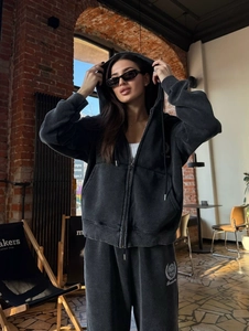 Détail d'un ensemble sweat à capuche gris foncé avec effet délavé et logo brodé