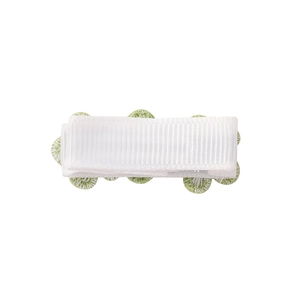 Detailed macro view of white ribbed fabric hair clip with green floral embroidery accents