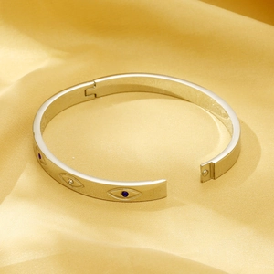 Polished silver titanium steel evil eye bangle with sparkling blue and white crystals