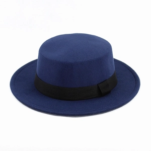 Close-up of a classic navy blue flat top felt hat with a black grosgrain decorative ribbon