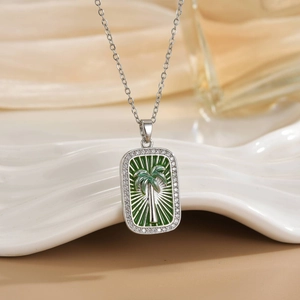 Silver tropical palm tree tarot necklace with green enamel and sparkling zircon border
