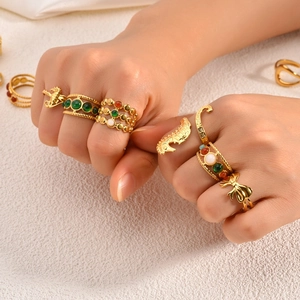Detailed close-up of 18k gold-plated stainless steel seahorse and gemstone stackable rings