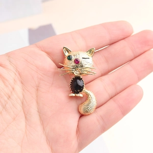 Exquisite golden cat brooch with black gemstone body and colorful jewel eyes