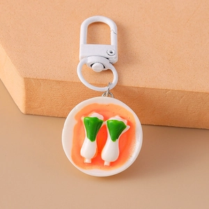 Macro shot of realistic green vegetable food pendant with white metal keyring hook