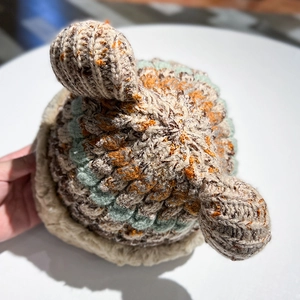 Close-up of colorful chunky knit beanie with cute ear details and mixed color weave pattern