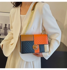 Fashionable color-block quilted shoulder bag with gold chain strap worn by a model