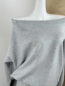 Detail view of heather grey off-shoulder sweatshirt showing cotton knit texture on a mannequin