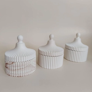 Detailed view of striped storage jars set with marble texture and round lid handles
