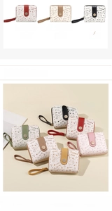 Close-up of cute cat print wallets in multiple colors with wrist strap and metal snap