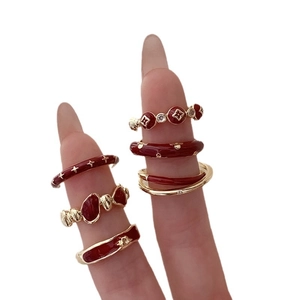 Vintage gold and red enamel flower ring set with star and bear motifs on hand