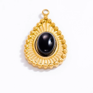 Macro detail of teardrop 18k gold plated stainless steel pendant with oval black onyx stone