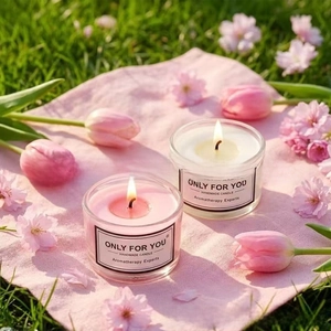 Close-up of handmade pink and white scented glass candles for a spa gift basket set