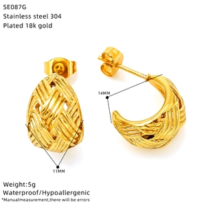 Detailed view of woven texture gold oval earrings with size markings 14x11mm and weight