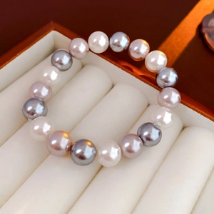 Close-up of multi-colored round pearls in a velvet jewelry box showing lustrous texture