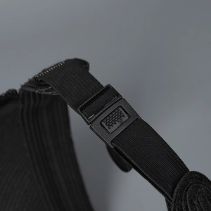 Detailed macro view of the black adjustable elastic strap and non-slip buckle on sun hat