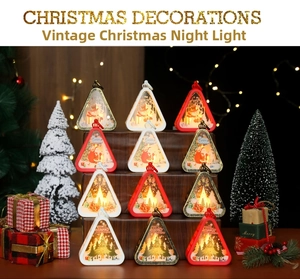 Close-up of vintage Christmas lanterns with Santa and reindeer scenes on display
