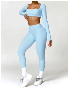 Close-up of light blue seamless high-waist fitness leggings and long sleeve crop top set