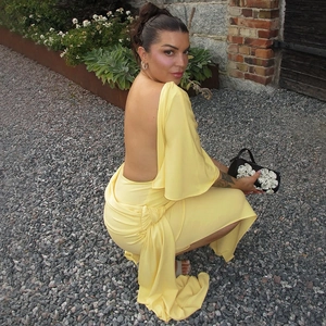 Detail of French style backless yellow dress featuring elegant draped pleats and long ties