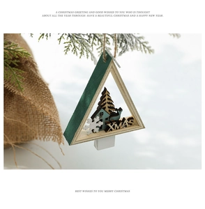 Close-up of a wooden triangle Christmas ornament featuring reindeer and XMAS engraving