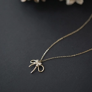 Elegant gold S925 sterling silver double-layer bow pendant necklace with sparkling zircons