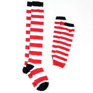 Close-up of red and white striped knit over-knee socks and arm warmer set with black trims